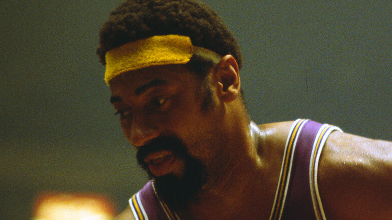 Wilt Chamberlain looking down yellow headband