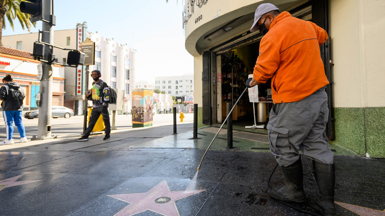 man cleaning the walk of fame
