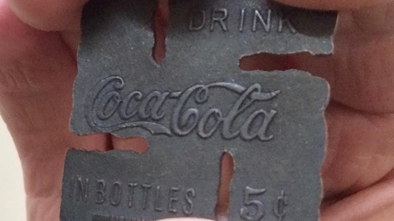 Man holds Coca-Cola swastika
