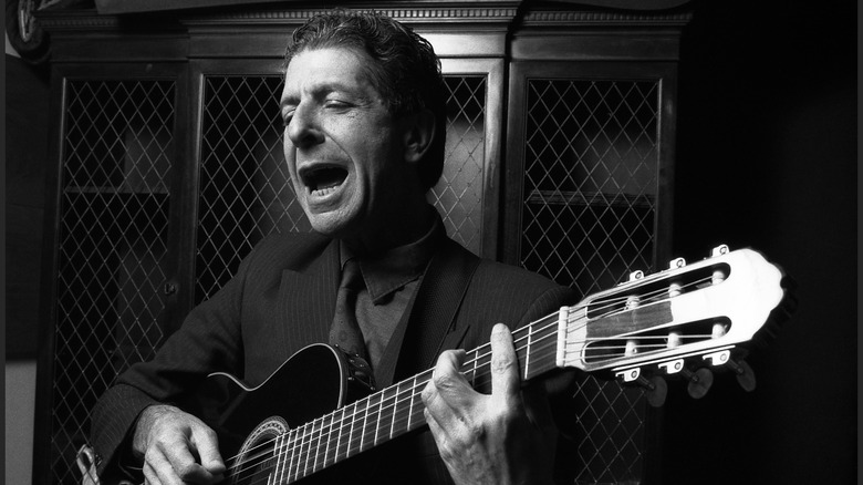 Leonard Cohen singing with guitar