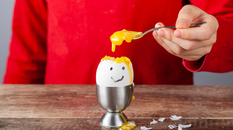 Child eating egg man's yolk brain