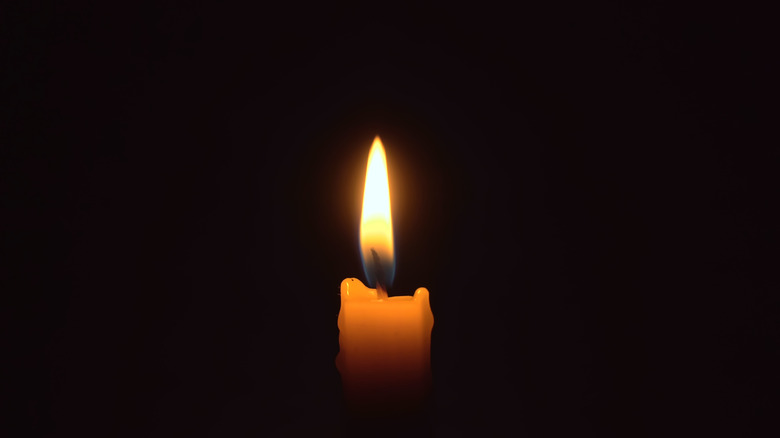 Candle in darkness