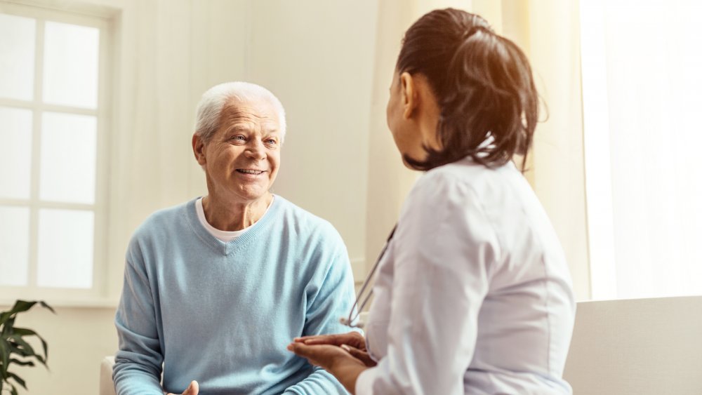 A doctor meeting with a senior citizen