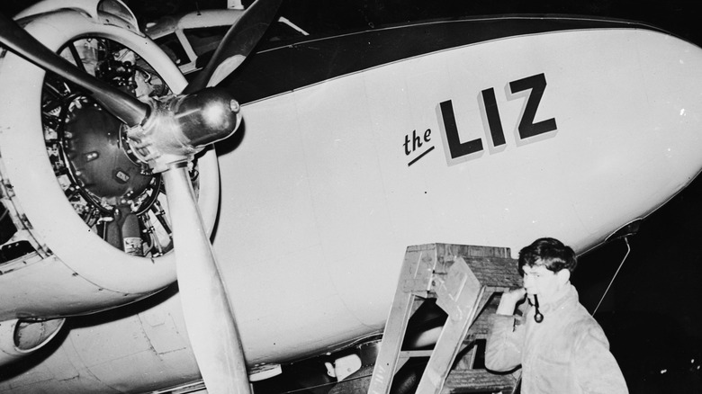 Plane mechanic holding ladder