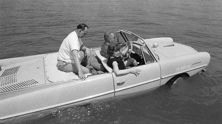 Lyndon Johnson driving his amphicar on a lake