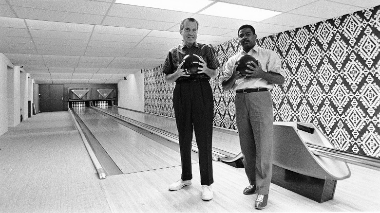 Richard Nixon bowling with Frank Blair in the White House 