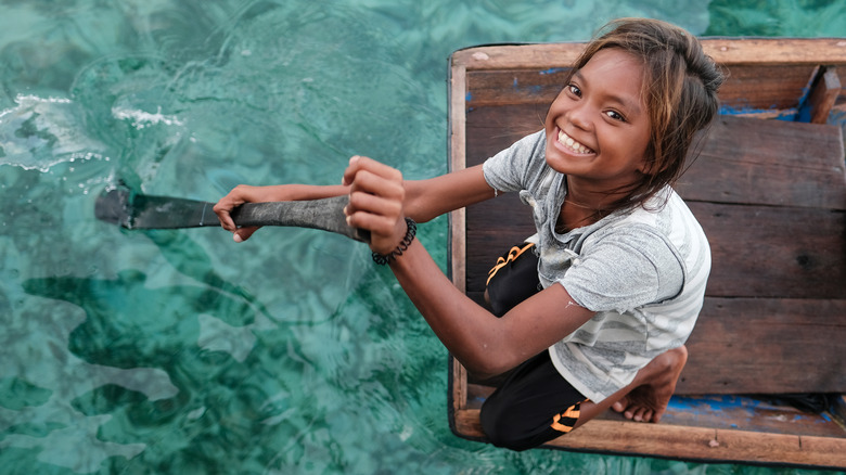 young majau rowing a boat