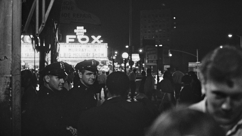 Two officers talk to pedestrian 