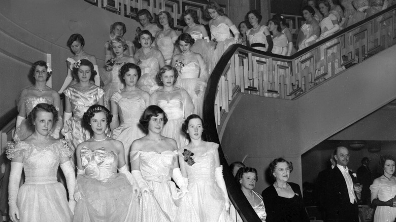 The massed ranks of debutantes at the Queen Charlotte's Ball at Grosvenor House descend into the ballroom