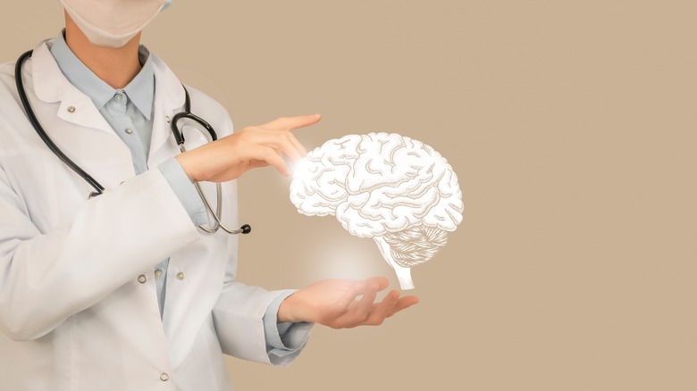 Doctor holding brain 