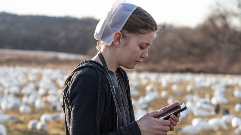 Young Amish girl checking phone