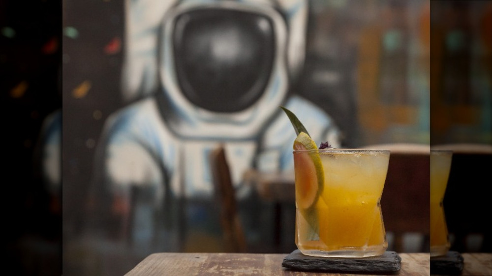 Astronaut gazing at forbidden cocktail