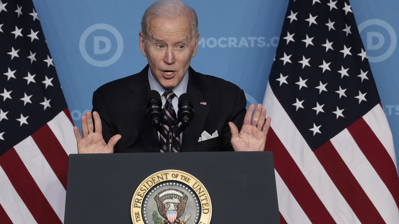 Joe Biden at podium with hands raised