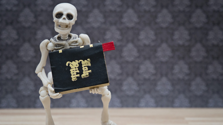 skeleton holding the Bible