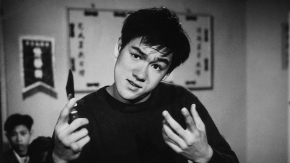 Bruce Lee with knife looking goofy