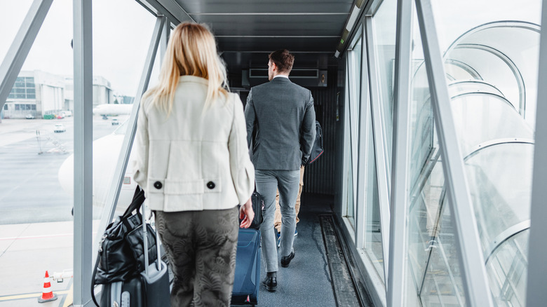 Passengers walking toward plane