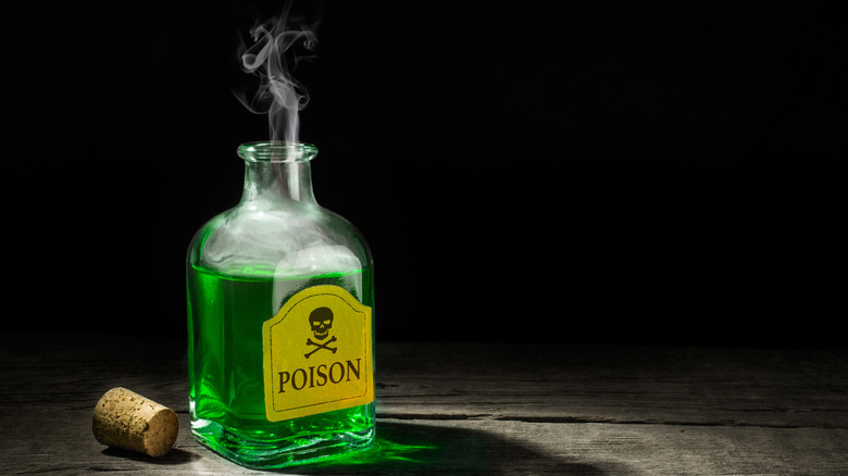 Glass bottle with green poison