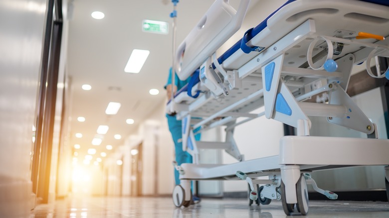 Hospital worker transporting hospital bed