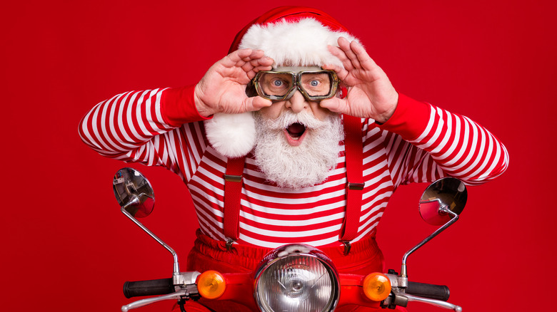Santa Claus high on sugar while riding a motorcycle