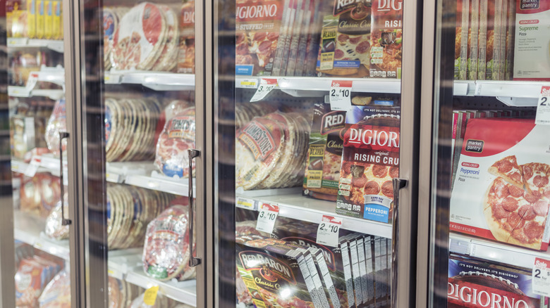 frozen pizzas in freezer