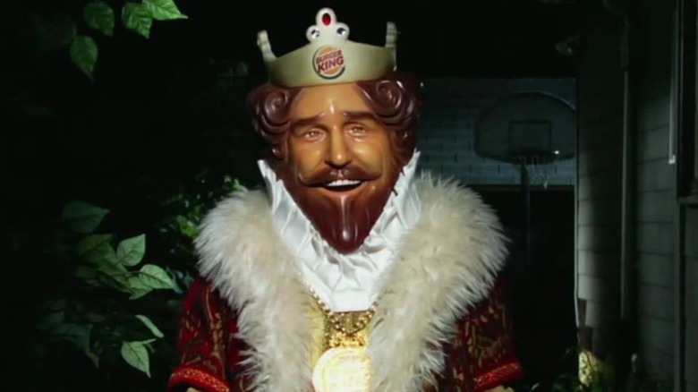 Burger King mascot standing in the dark