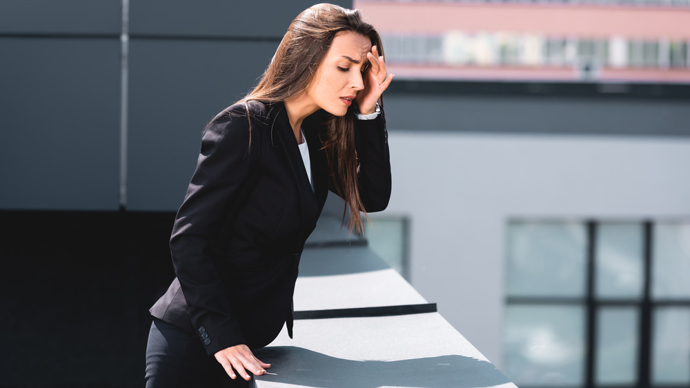 A concerned woman peers downward