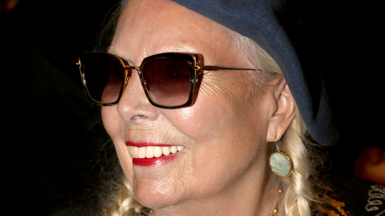 Joni Mitchell wearing sunglasses and smiling