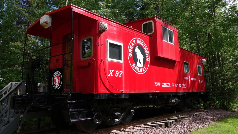 caboose is parked on a rail track