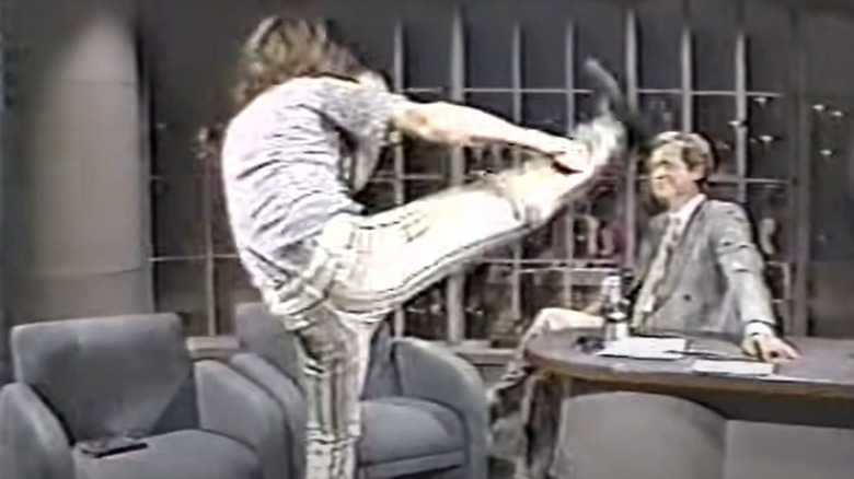 Crispin Glover kicking during interview