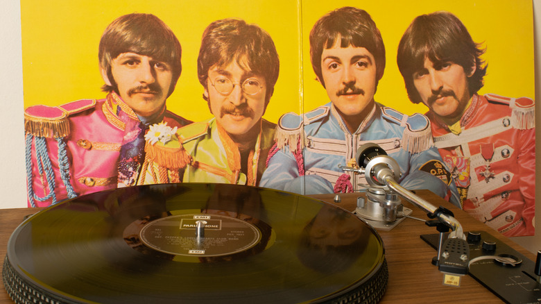 The Beatles on record sleeve with record player
