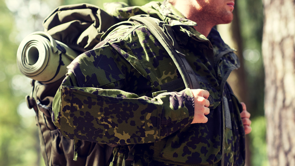 Soldier carries gear