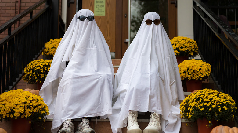 Two people dressed as ghosts