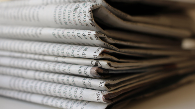 A stack of folded newspapers