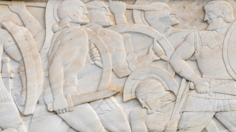 marble wall depicting ancient greek warriors