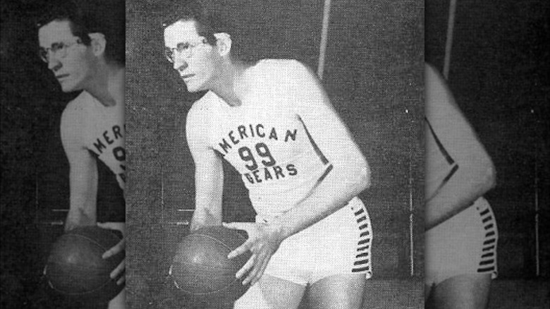 George Mikan holding ball