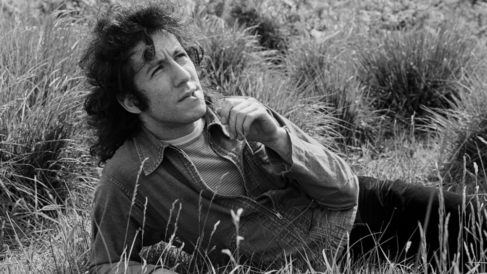 A young Peter Green reclining in the grass