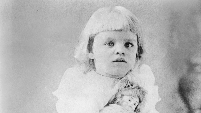 Young Eleanor Roosevelt playing with a doll