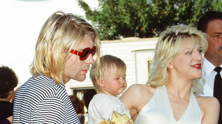 Kurt Cobain and Courtney Love holding their daughter Frances Bean Cobain