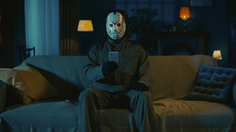 Hockey mask villain sitting on couch