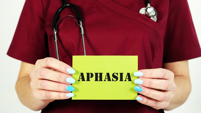 Doctor holding an "aphasia" paper