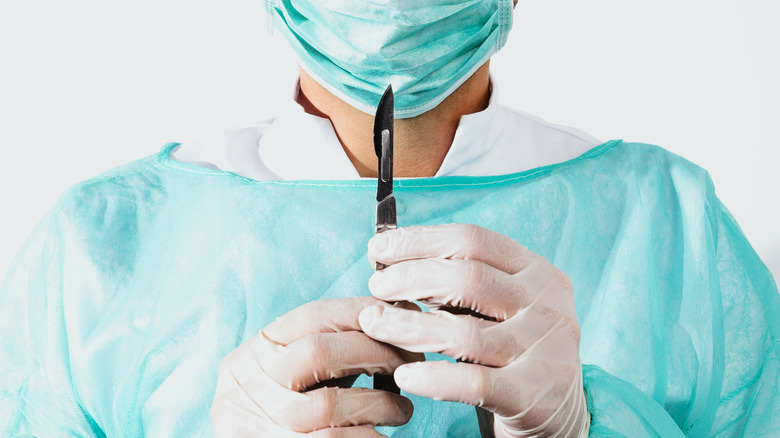 Surgeon holding scalpel