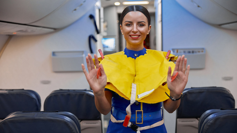 Plane stewardess in lifejacket