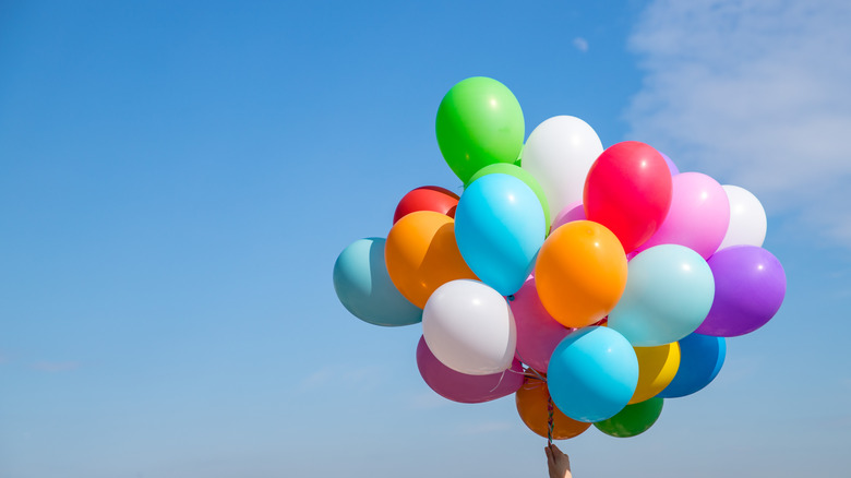 Group of balloons being held in the air by a string