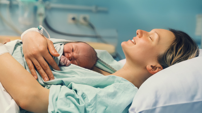 Mother with baby on hospital bed