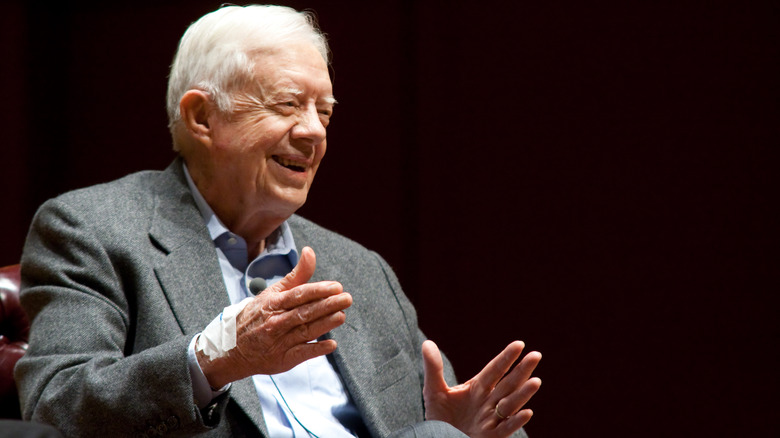 Jimmy Carter sitting while speaking