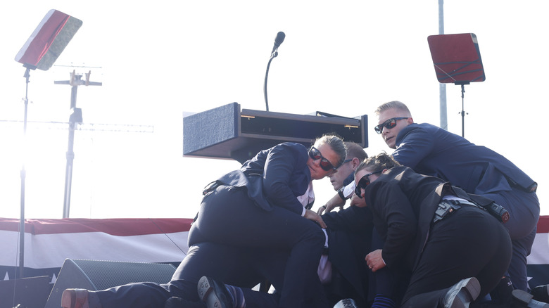 Secret Service agents protecting Donald Trump on stage