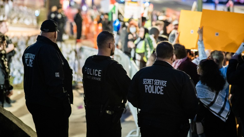 Three secret service agents with backs to camera