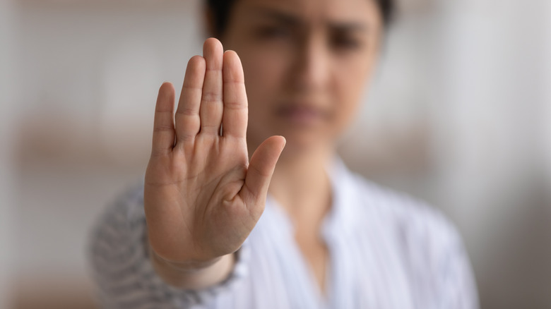 woman holding up hand 