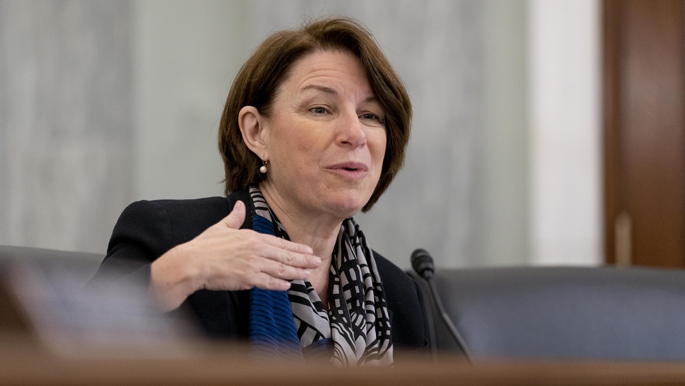 Amy Klobuchar talking with hand raised