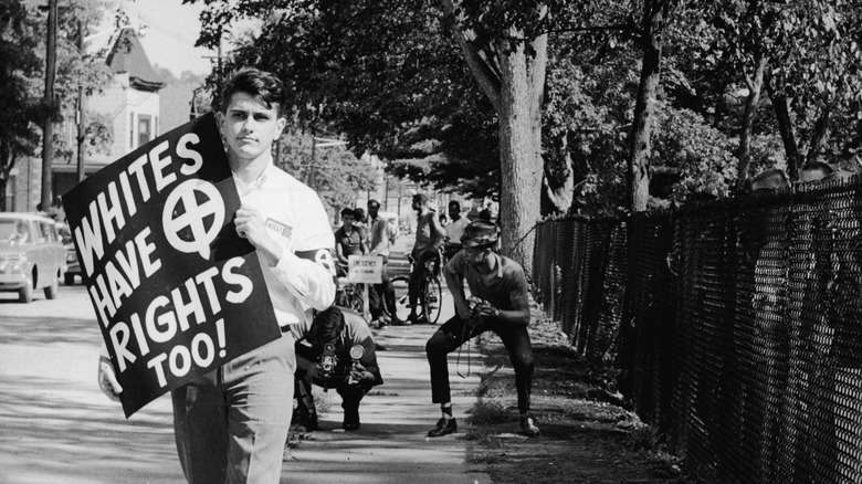 Nazi supporter John Patler holding protest sign